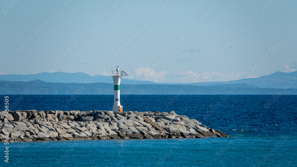 Seascape with a lighthouse on the Kuzu Limani harbour, on the island of Gokceada, Canakkale, Turkey.