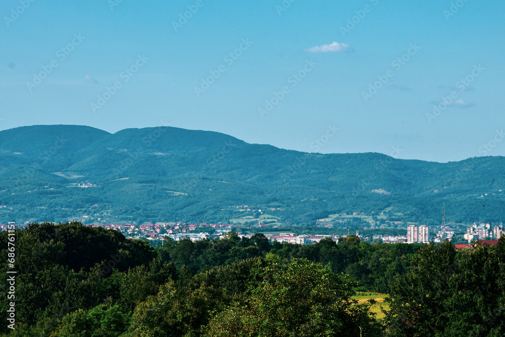 Landscape and panorama. View of the village, nature, and city at the foot of the mountain. A high mountain in the background