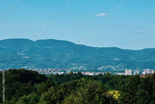 Landscape and panorama. View of the village, nature, and city at the foot of the mountain. A high mountain in the background