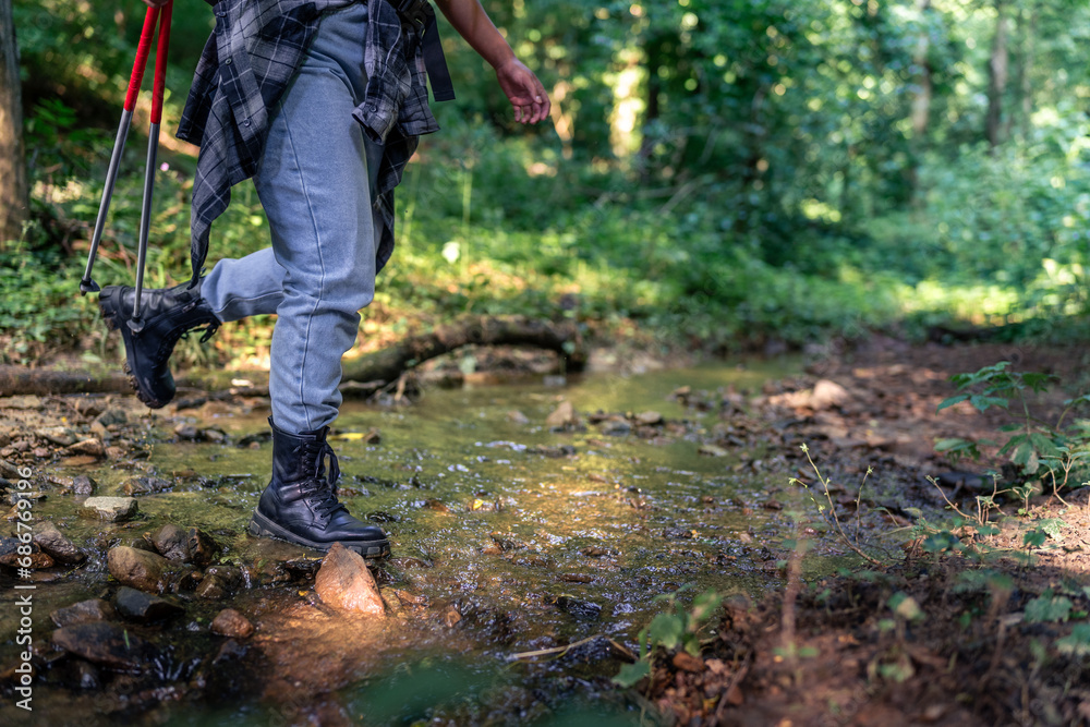 close up image of boots walking through water, hiking concept close up image of boots walking through water, hiking concept