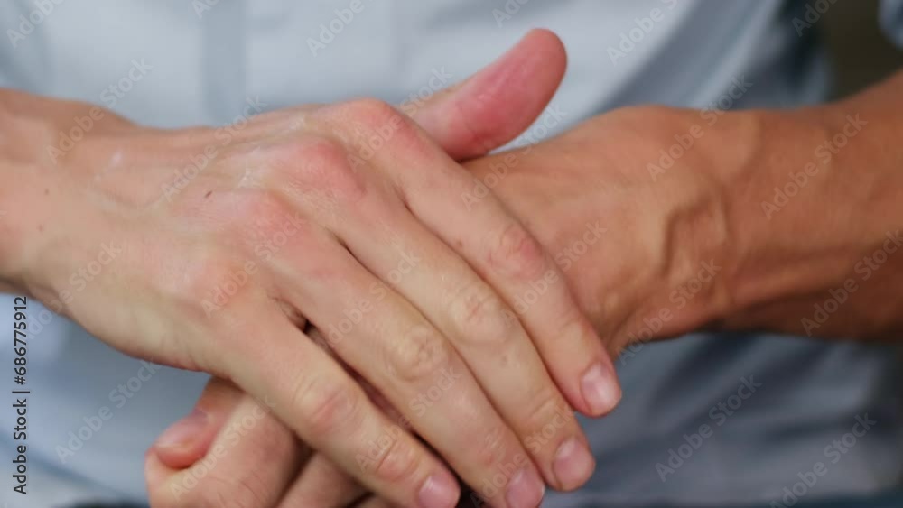 Young man smearing a white moisturizer on his hands close-up. Morning routine. Beauty and care concept. Young man smearing a white moisturizer on his hands close-up. Morning routine. Beauty and care concept.