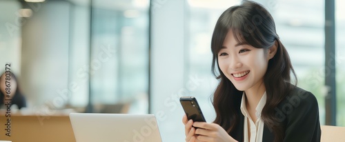 japanese business woman holding phone using cellphone in office. Smiling professional businesswoman executive using smartphone cell mobile apps on cellphone working sitting at desk. generative AI photo