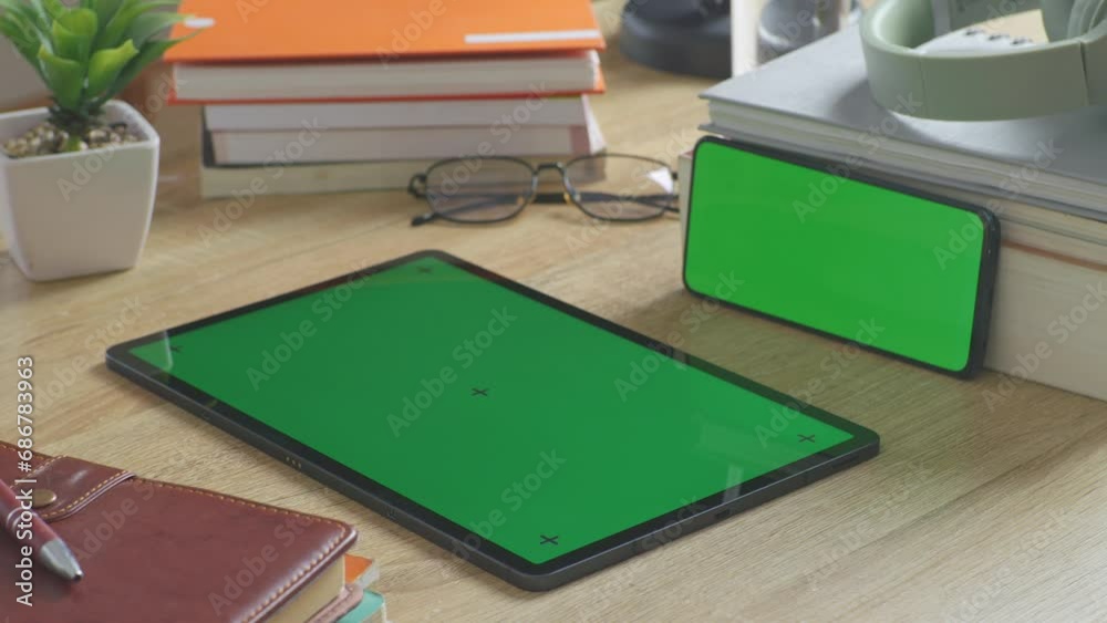 Close Up Of Mock Up Green Screen Chromakey Tablet And Smartphone On A Desk With Notebook, Pens, Headphones, And A Glass Of Water At The Office
Close Up Of Mock Up Green Screen Chromakey Tablet And Smartphone On A Desk With Notebook, Pens, Headphones, And A Glass Of Water At The Office