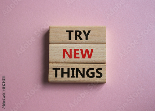 Try new Things symbol. Concept words Try new Things on wooden blocks. Beautiful pink background. Business and Try new Things concept. Copy space.
