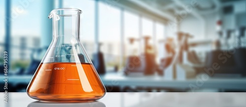 Orange solution in a conical flask found in a science lab at a school or university Copy space image Place for adding text or design
