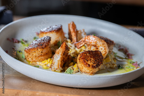 Seared scallops and shrimp on a bed of succotash.