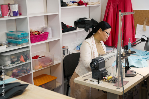 Female at workplace working with blue cloth photo