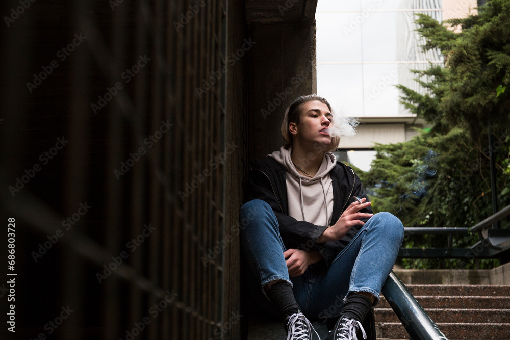 Young man smoking cigarette Young man smoking cigarette
