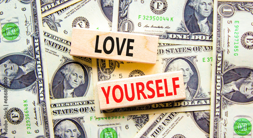 Love yourself symbol. Concept words Love yourself on beautiful wooden blocks. Dollar bills. Beautiful background from dollar bills. Psychology love yourself concept. Copy space.
