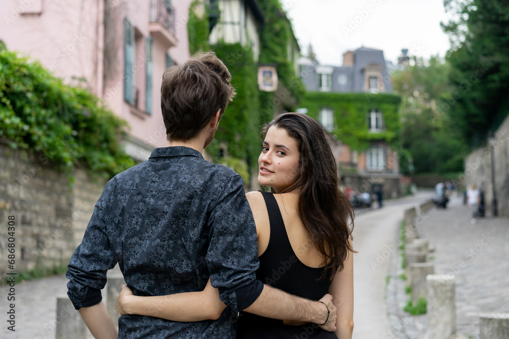 France, Paris, young couple in an alley in the district Montmartre