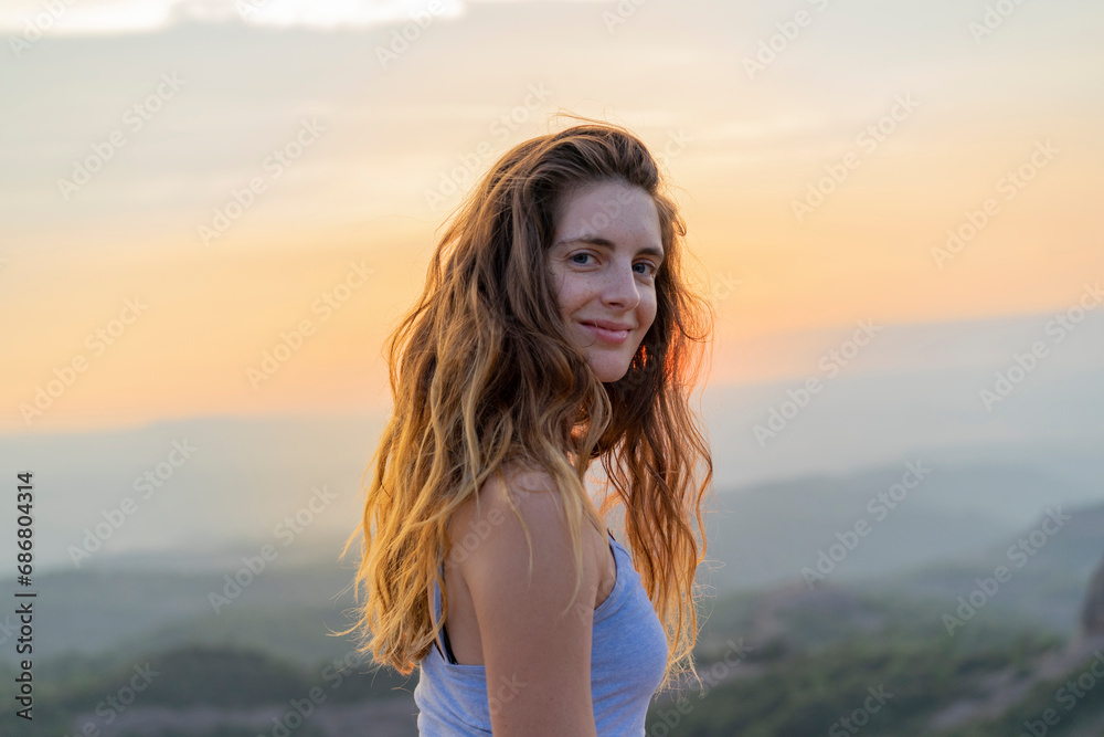 Woman watching sunset in the mountains