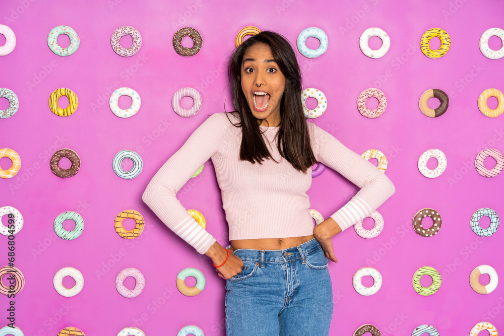 Young woman screaming at an indoor theme park with donuts at the wall Young woman screaming at an indoor theme park with donuts at the wall
