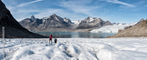 Greenland, Sermersooq, Kulusuk, Schweizerland Alps, group of people walking in snow photo