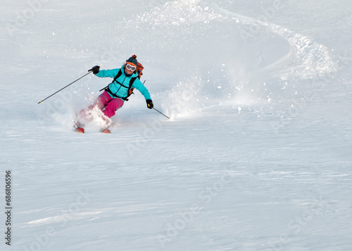 Switzerland, Grand Saint Bernard Pass, Pain de Sucre, Mont Fourchon, woman on a ski tour in the mountains riding downhill