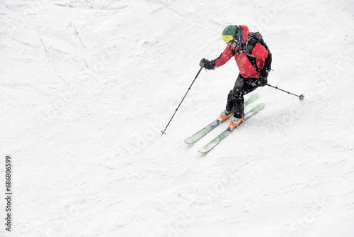 Georgia, Caucasus, Gudauri, man on a ski tour riding downhill