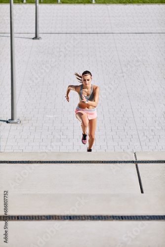 Fit young woman running on stairs