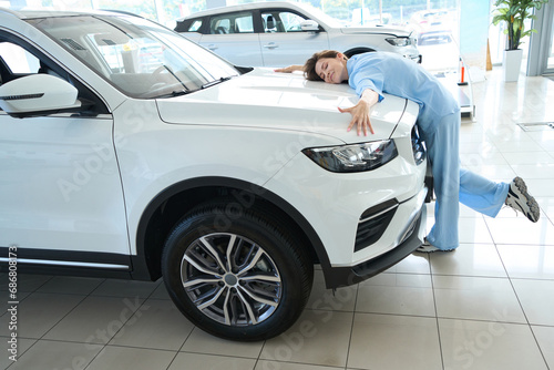 Photo of attractive female in car showroom
