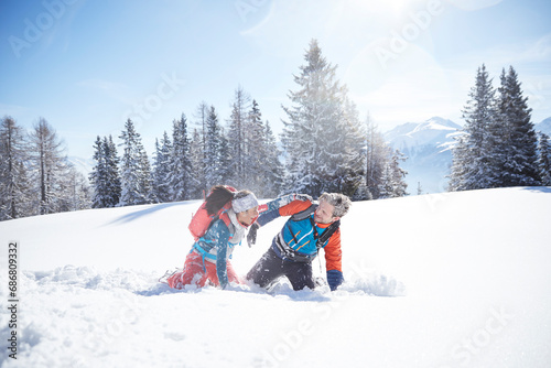 Austria, Tyrol, couple having fun in the snow