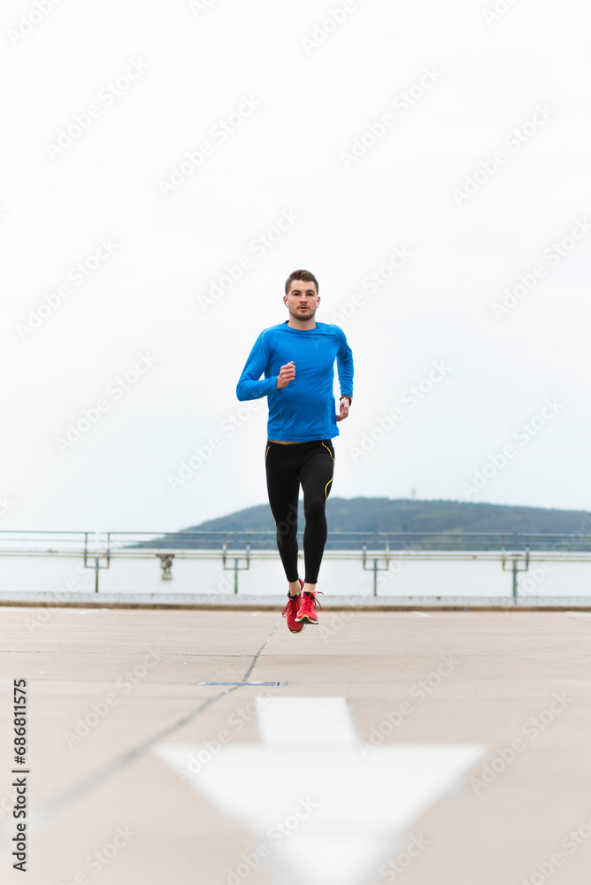 Young man running on parking level Young man running on parking level