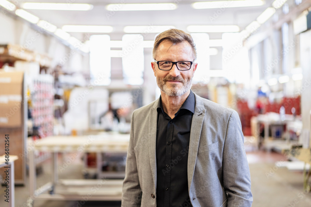 Portrait of confident businessman in factory