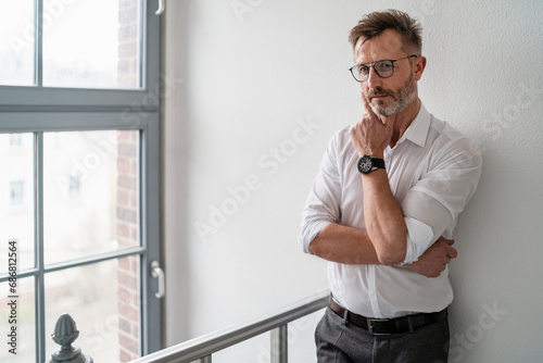 Portrait of businessman at the window in office