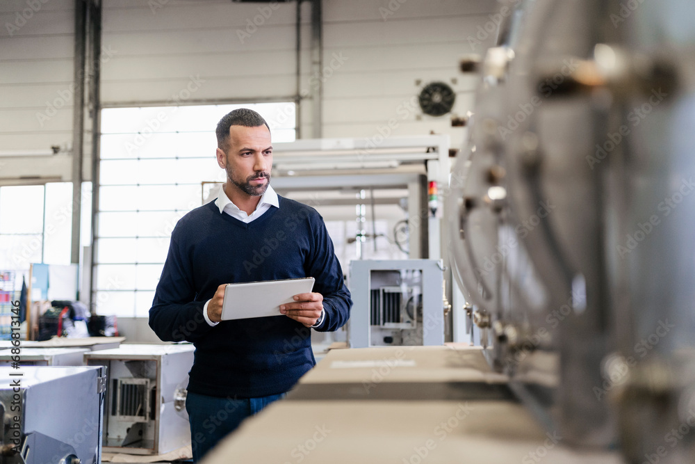 Businessman using tablet in a factory Businessman using tablet in a factory