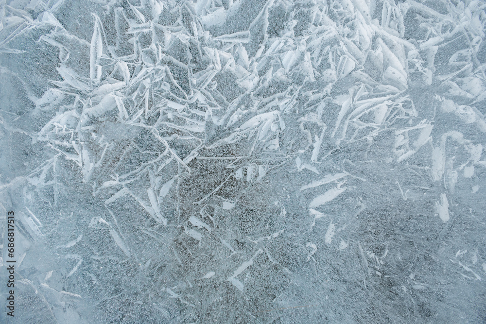 Background frozen water with fancy patterns. Ice texture. Cracks and bubbles inside frozen water. Background frozen water with fancy patterns. Ice texture. Cracks and bubbles inside frozen water.