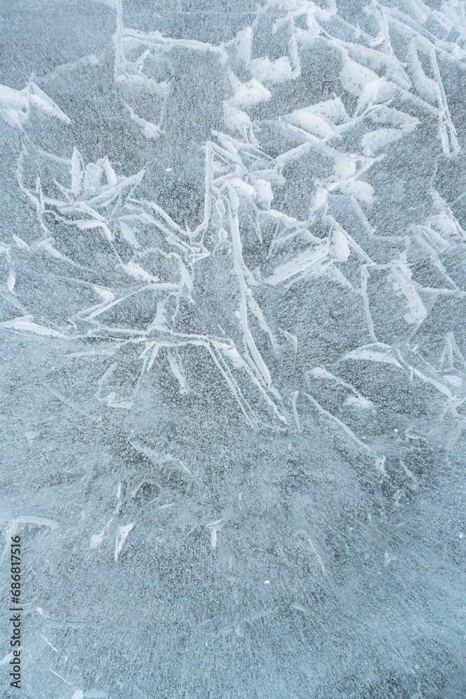 Background frozen water with fancy patterns. Ice texture. Cracks and bubbles inside frozen water. Background frozen water with fancy patterns. Ice texture. Cracks and bubbles inside frozen water.