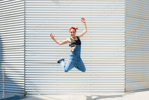 Smiling young woman jumping in the air