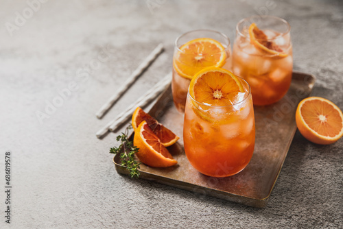 Fresh orange ice drinks served in glasses on the table photo