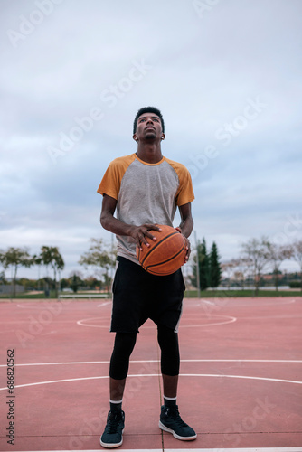 Teenager playing basketball