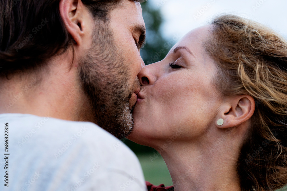 Affectionate couple kissing in nature Affectionate couple kissing in nature
