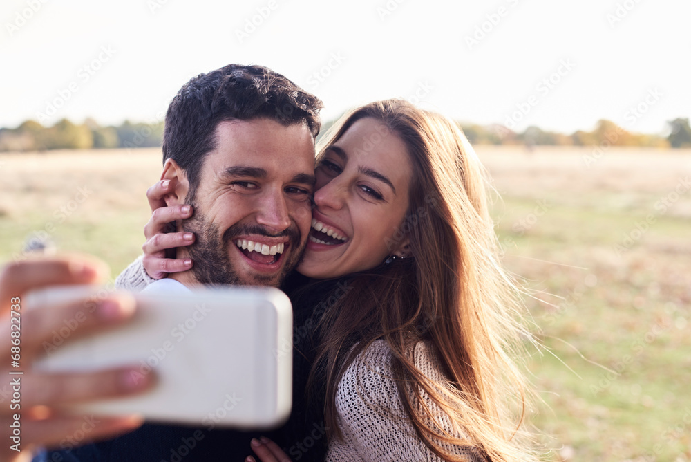 Happy couple taking a selfie in a park Happy couple taking a selfie in a park