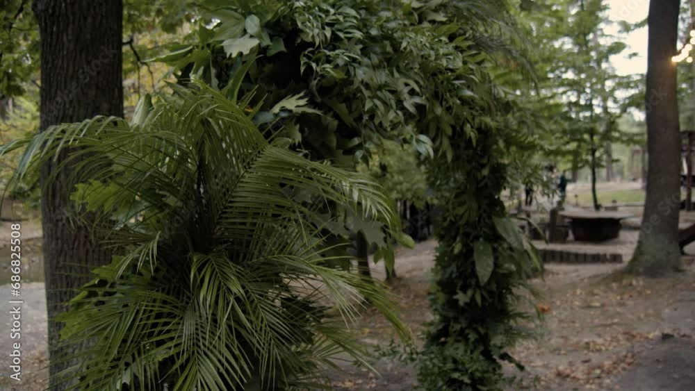 Wedding decor. Area of the wedding ceremony. Arch decorated with green. Part of the festive decor, green arrangement. Slow motion. Wedding decor. Area of the wedding ceremony. Arch decorated with green. Part of the festive decor, green arrangement. Slow motion.