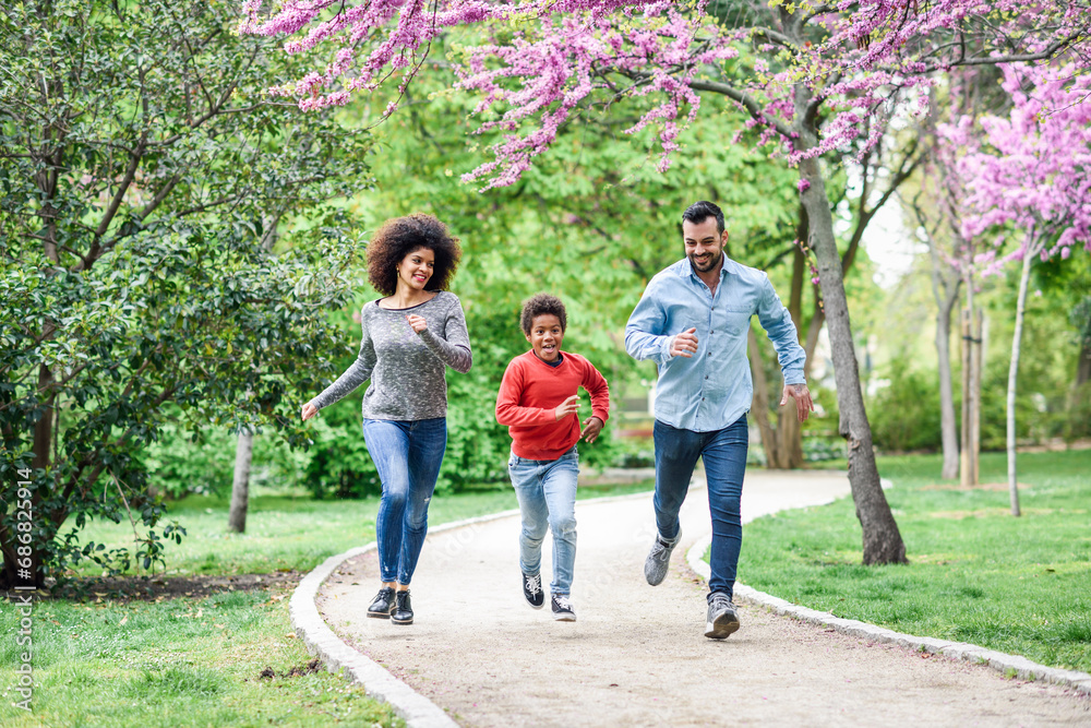 Happy family running and playing in a park Happy family running and playing in a park
