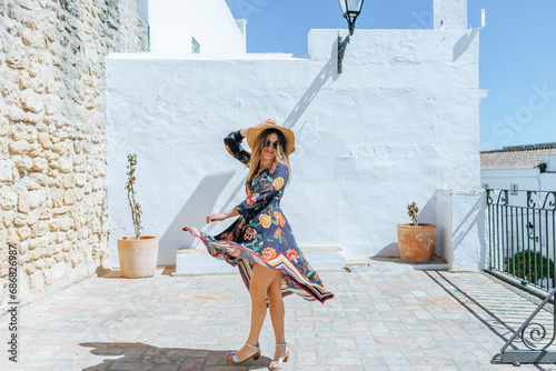 Spain, Cadiz, Vejer de la Frontera, portrait of fashionable woman moving on roof terrace photo