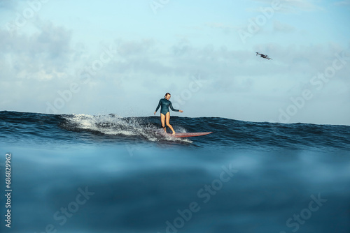 Female Surfer and drone, Bali, Indonesia