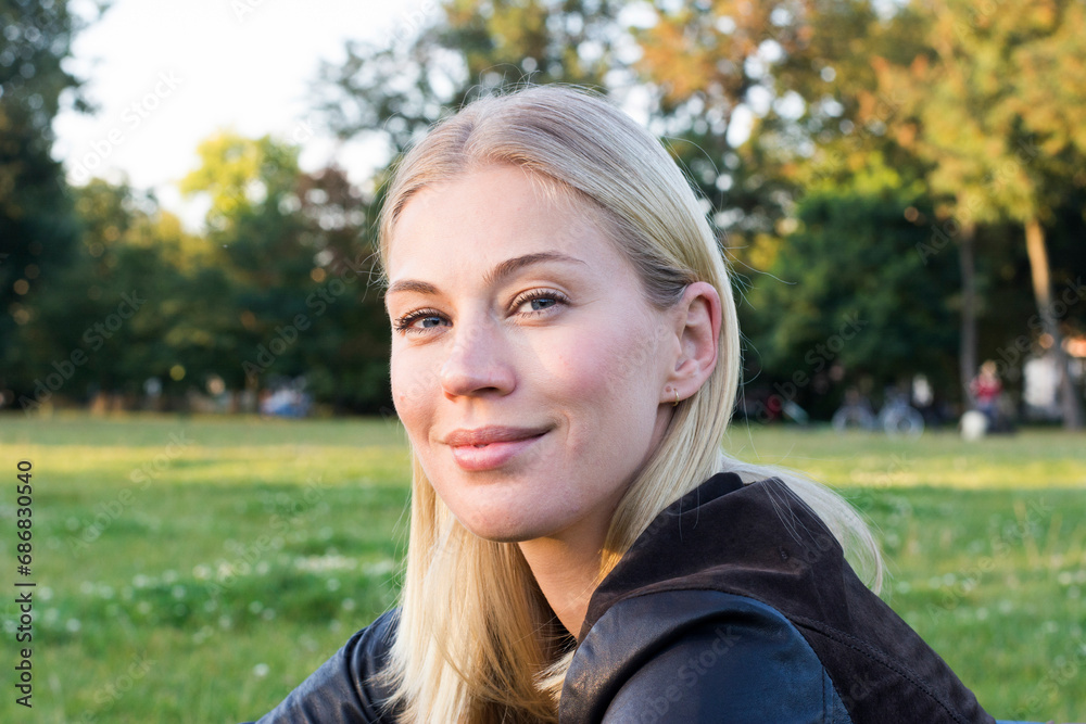 Portrait of content blond woman relaxing in a park Portrait of content blond woman relaxing in a park