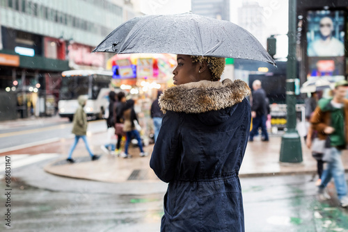 USA, New York City, young woman with umbrella on rainy day