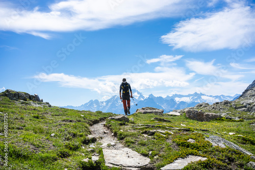 Man hiking on mountain path at Western Rhaetian Alps, Sondrio, Italy photo