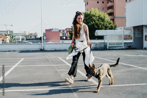 Woman walking with dog in parking lot
