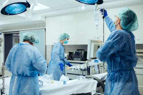 Doctor preparing IV drip in trauma room of a hospital photo