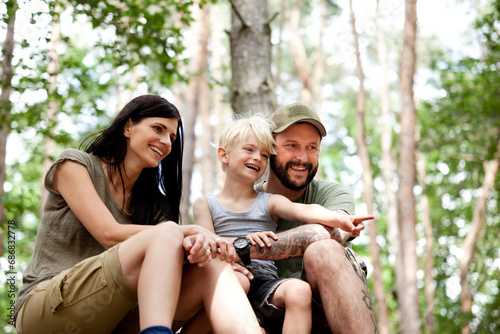 Happy family with son sitting in forest