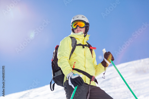 Austria, Bludenz, woman with ski helmet and avalanche backpack in the mountains