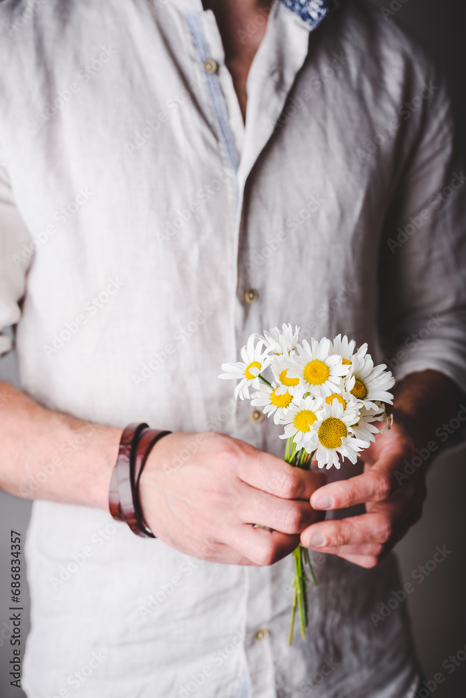 Bouquet of Freshly Picked Daisy Flowers in Male Hands Bouquet of Freshly Picked Daisy Flowers in Male Hands