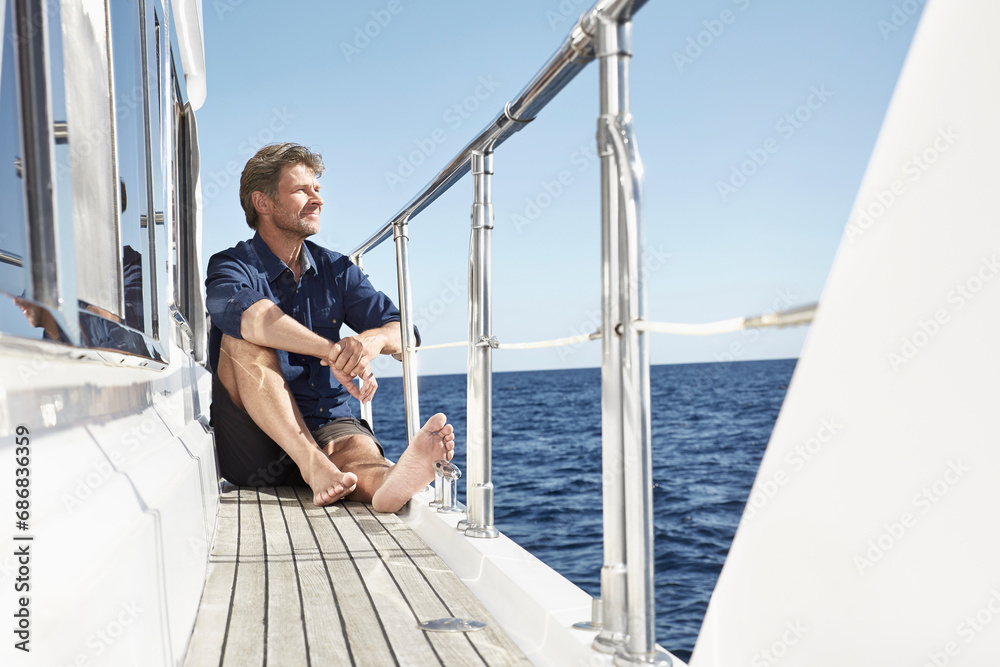 Content mature man sitting on his motor yacht