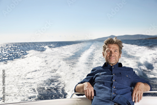 Portrait of content mature man on his motor yacht