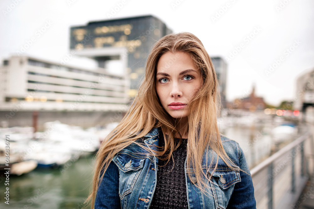 Portrait of attractive young woman at city harbor