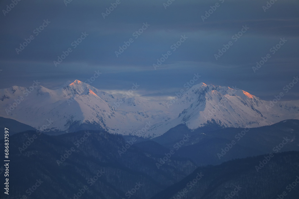 Winter alpine landscape in National Park Retezat, Carpathians, Romania, Europe. Snow covered moutains scenery