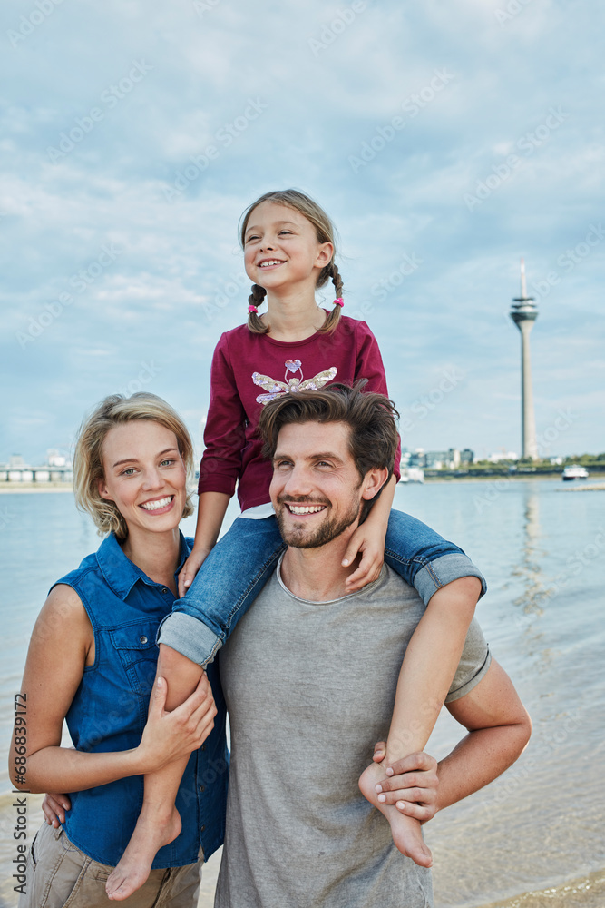 Germany, Duesseldorf, happy family with daughter at Rhine riverbank